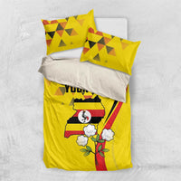 Yellow bedding set with duvet and two pillowcases; Uganda crest with flowers and stripes