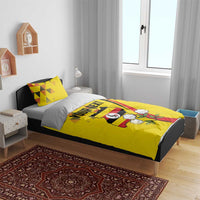 Yellow duvet cover on bed with two matching pillowcases and Uganda crest graphic