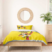 Yellow bedding set with duvet and pillowcases; Uganda crest and crowned crane on bed