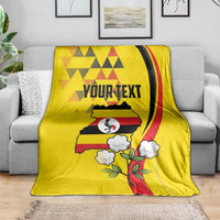 Yellow Independence Day blanket draped on sofa; crowned crane bird with custom text and map
