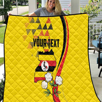 Yellow personalized quilt with centered Uganda motif, text panel, and black border trim