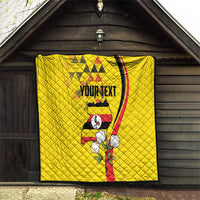 Yellow personalized quilt hanging outdoors with centered Uganda bird and “YOURTEXT” text