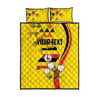 Yellow quilt bed set with two pillows, crowned crane emblem, clouds, leaves, and text