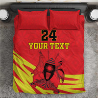 Red bedding set with kente-style stripes, Coat of Arms graphic, and “24 YOUR TEXT”