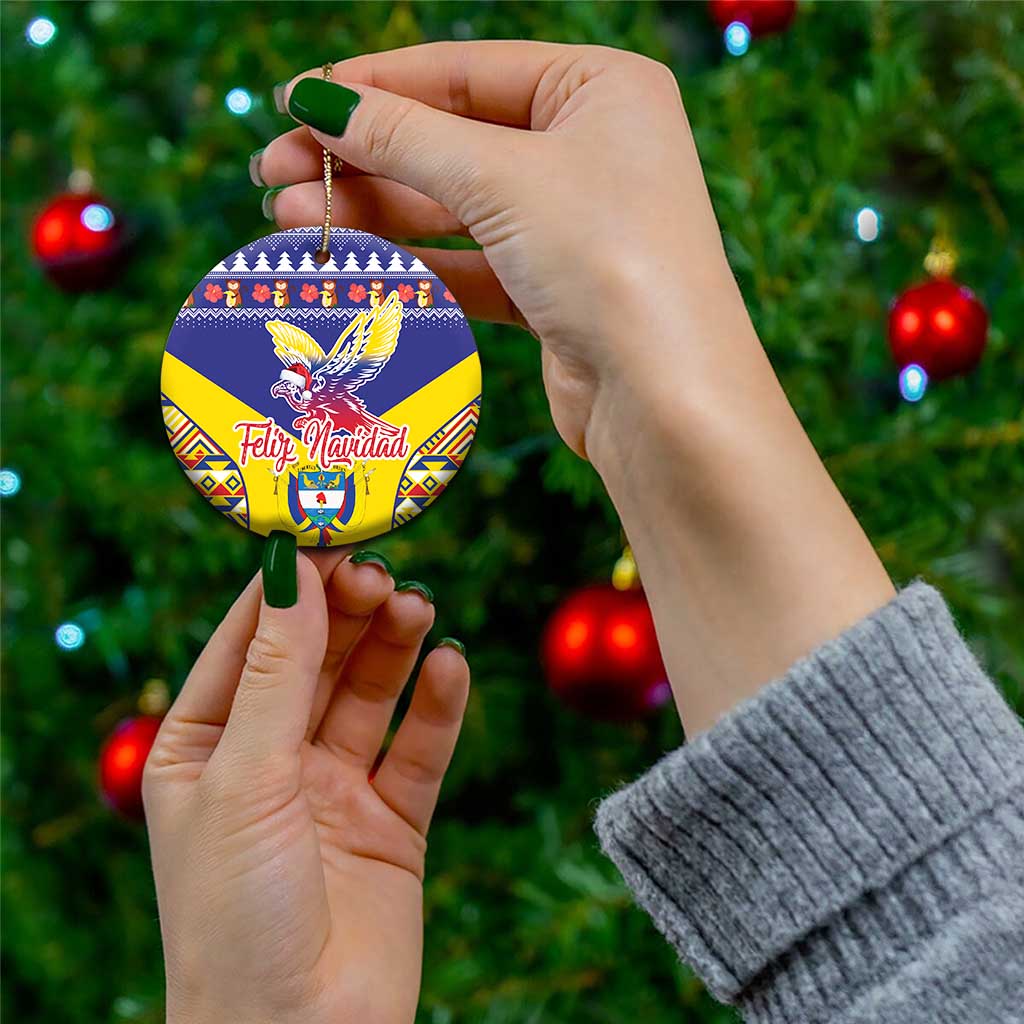 Blue circular ceramic ornament with Andean condor and Colombia festive pattern, held by hands