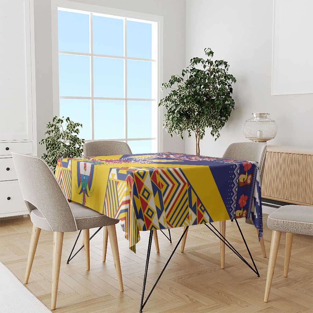Geometric blue and yellow tablecloth draped over dining table with matching chairs