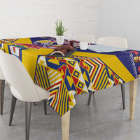 Geometric blue and yellow tablecloth with condor motif, neatly draped on dining table