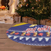 Blue and yellow round tree skirt with festive border pattern and condor design