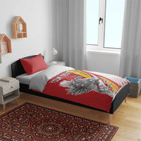 Red and white duvet bedding set with red pillowcases and “YOUR TEXT” on bed
