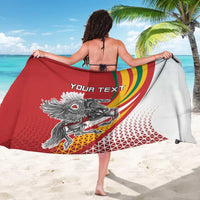 Red/white sarong with "YOUR TEXT" and Vytis emblem, tricolor swoosh, wrapped