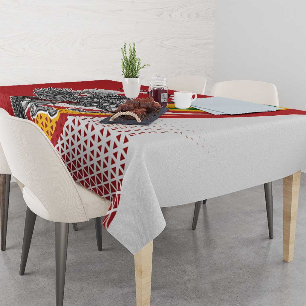 Red tablecloth detail with Vytis emblem, geometric lattice pattern, and draped corners.