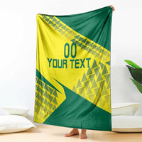 Volleyball blanket in yellow and green geometric design with 'YOUR TEXT' hanging over floor