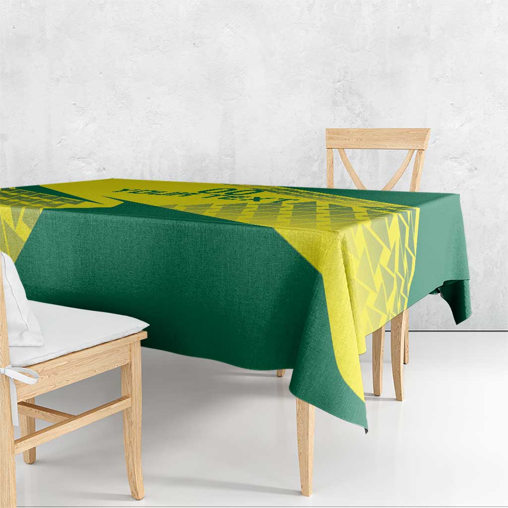 Green and yellow volleyball tablecloth draped over wooden bench and side table