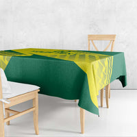 Green and yellow volleyball tablecloth draped over wooden bench and side table