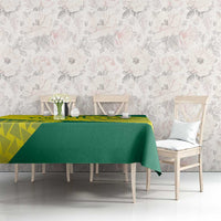 Green and yellow volleyball tablecloth on dining table with matching chairs