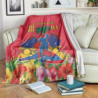 Red Haiti independence blanket with palm tree, floral border, and illustrated figure