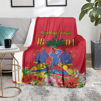 Red Haiti independence blanket over gray couch with palm tree and illustrated emblem