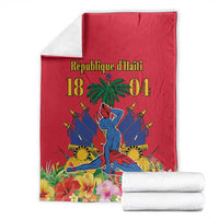 Red Haiti independence blanket folded with palm tree, swords, and floral border