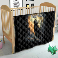 Black quilt blanket on crib with wolf howling under moon graphic and quilted pattern