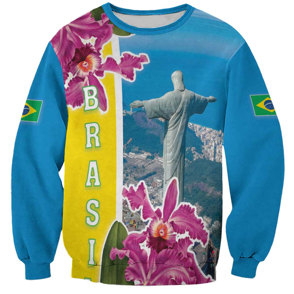 Blue crewneck sweatshirt, Christ statue in center with Brazil flag strip and pink orchids