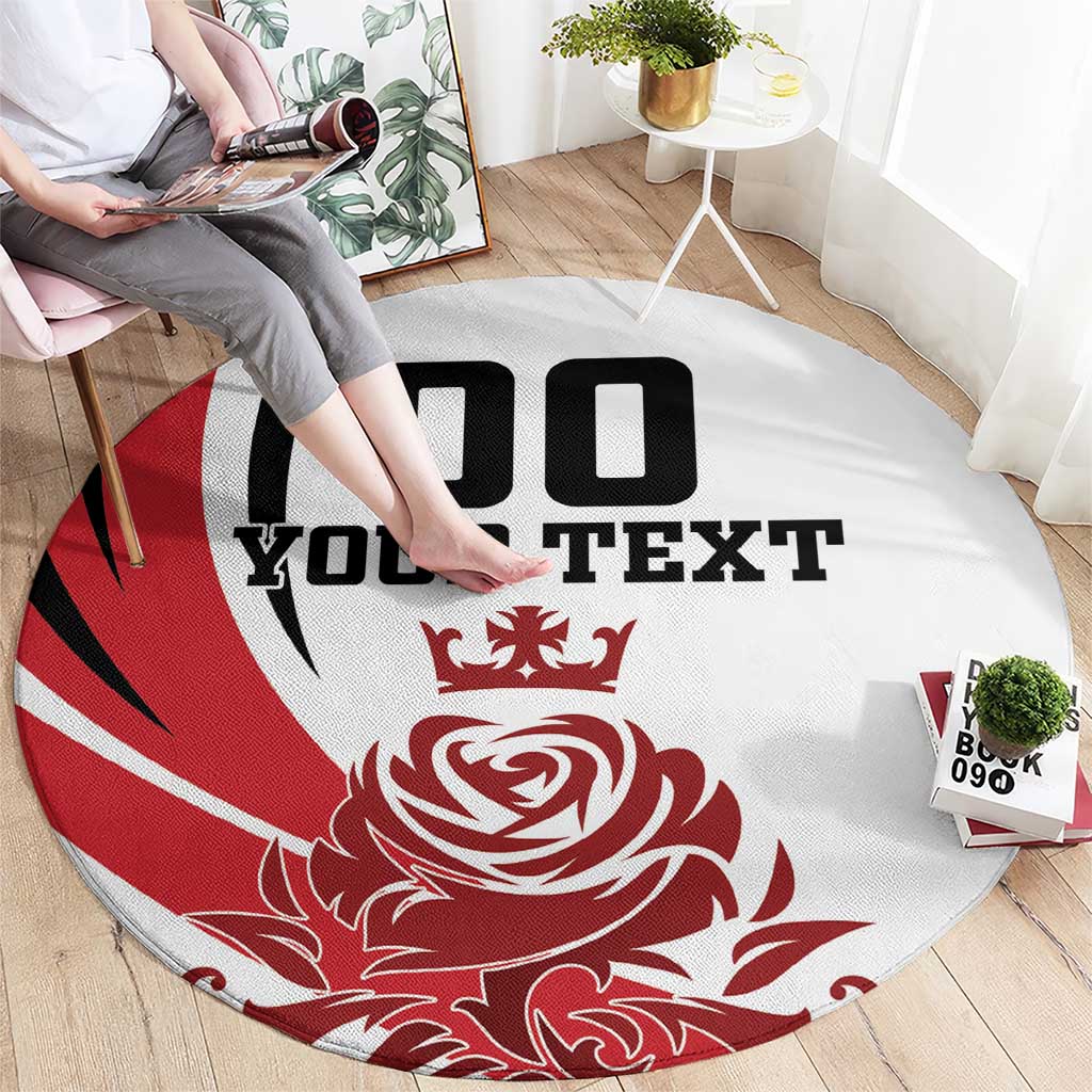 Person sitting on round red-and-white carpet with black "YOUR TEXT" and rose emblem