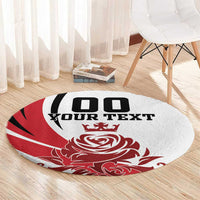 Round red and white rug on wood floor with black "YOUR TEXT" and crown rose design