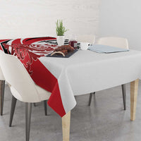 Red and white football tablecloth on dining table with small centerpiece items
