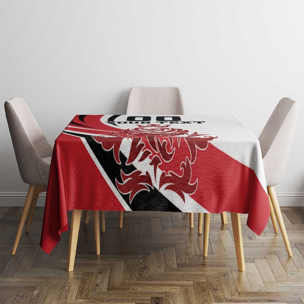 Red, white and black tablecloth on dining table with crest and text