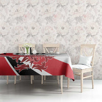 Red, white and black football tablecloth on dining table against floral wall