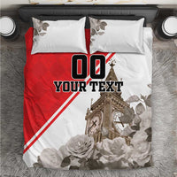 Close-up bedding set: red-and-white duvet with “YOUR TEXT” and clock tower illustration