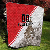 Red and white quilt with diamond quilting, Big Ben graphic, and 'YOUR TEXT'.