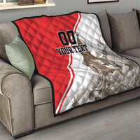 Red and white quilt on sofa, quilted pattern, Big Ben print, and 'YOUR TEXT'.