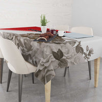 White tablecloth with gray floral rose print and red accent stripe on dining table
