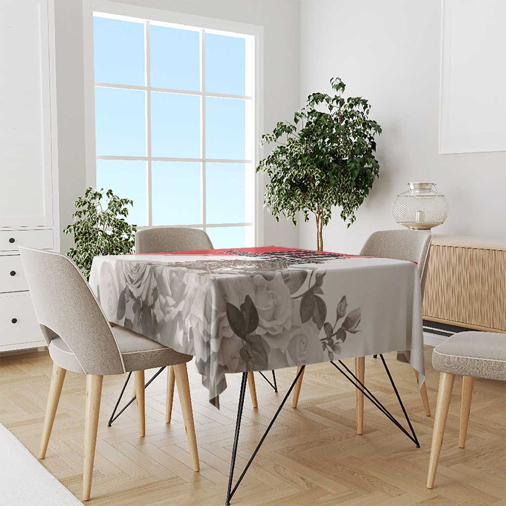 White tablecloth with gray rose and leaf print and red edge stripe on round dining table