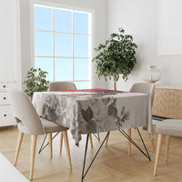 White tablecloth with gray rose and leaf print and red edge stripe on round dining table
