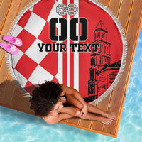 Red and white round beach blanket with checkered corner, bold “YOUR TEXT” and fringe
