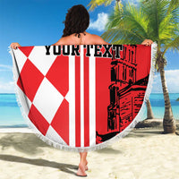 Red and white round beach blanket with checkered pattern, fringe trim, black architecture print