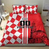 Red and white bedding set featuring two pillows and checkerboard panel with skyline art