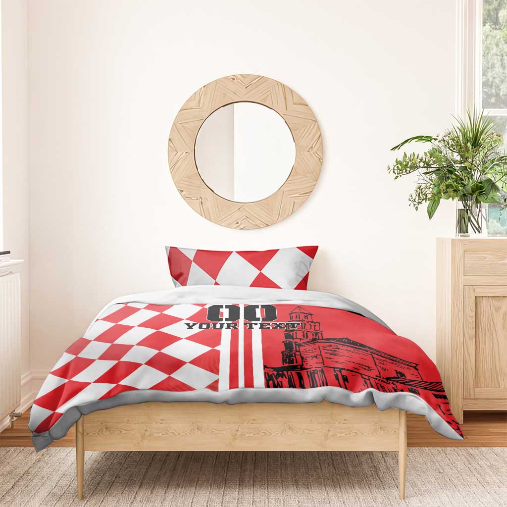 Red and white bedding set with checkerboard duvet, two pillows, and skyline graphic