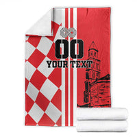 Folded red and white checkerboard blanket with 'YOUR TEXT' and skyline graphic
