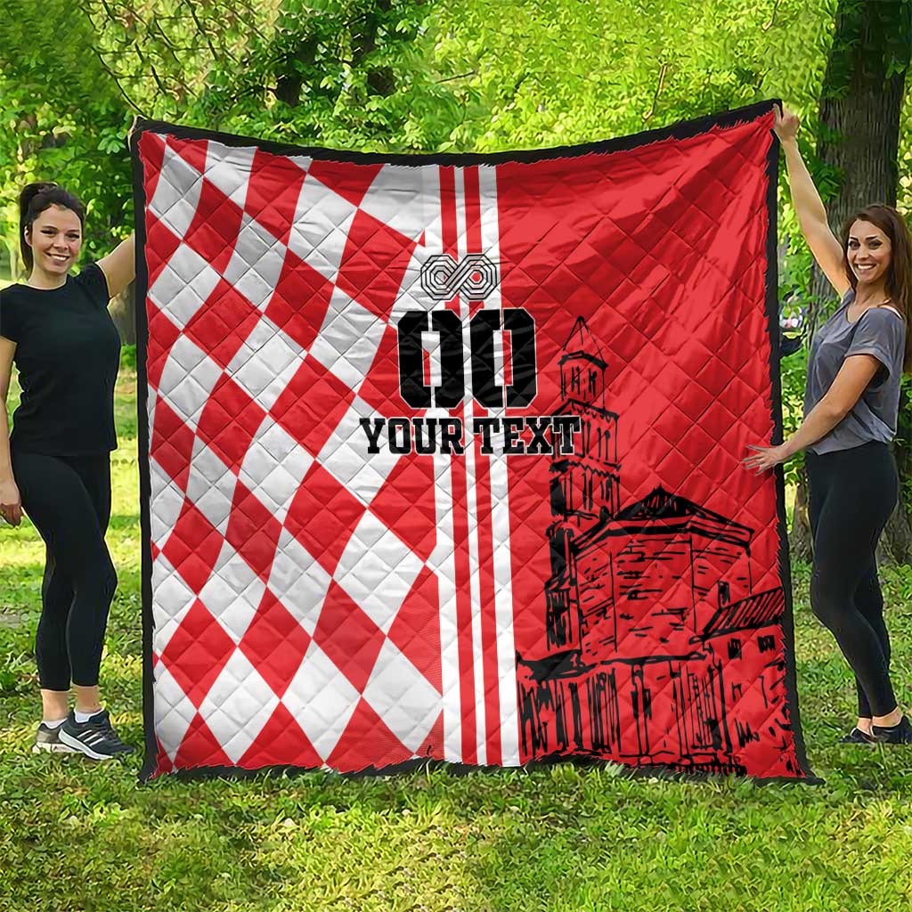Red and white checkerboard quilt with black city graphic, draped outdoors
