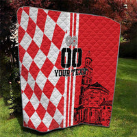Red and white checkerboard quilt with black Croatia city skyline graphic, on grass