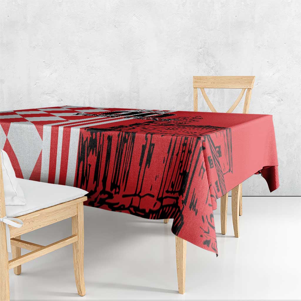 Red tablecloth with red-and-white geometric stripes and building skyline print
