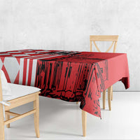 Red tablecloth with red-and-white geometric stripes and building skyline print