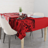 Red tablecloth with red-and-white stripes, city skyline print, and draped corners