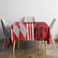 Red-and-white geometric tablecloth featuring skyline silhouette on tabletop