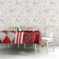 Red tablecloth with red-and-white geometric pattern and skyline design on dining table