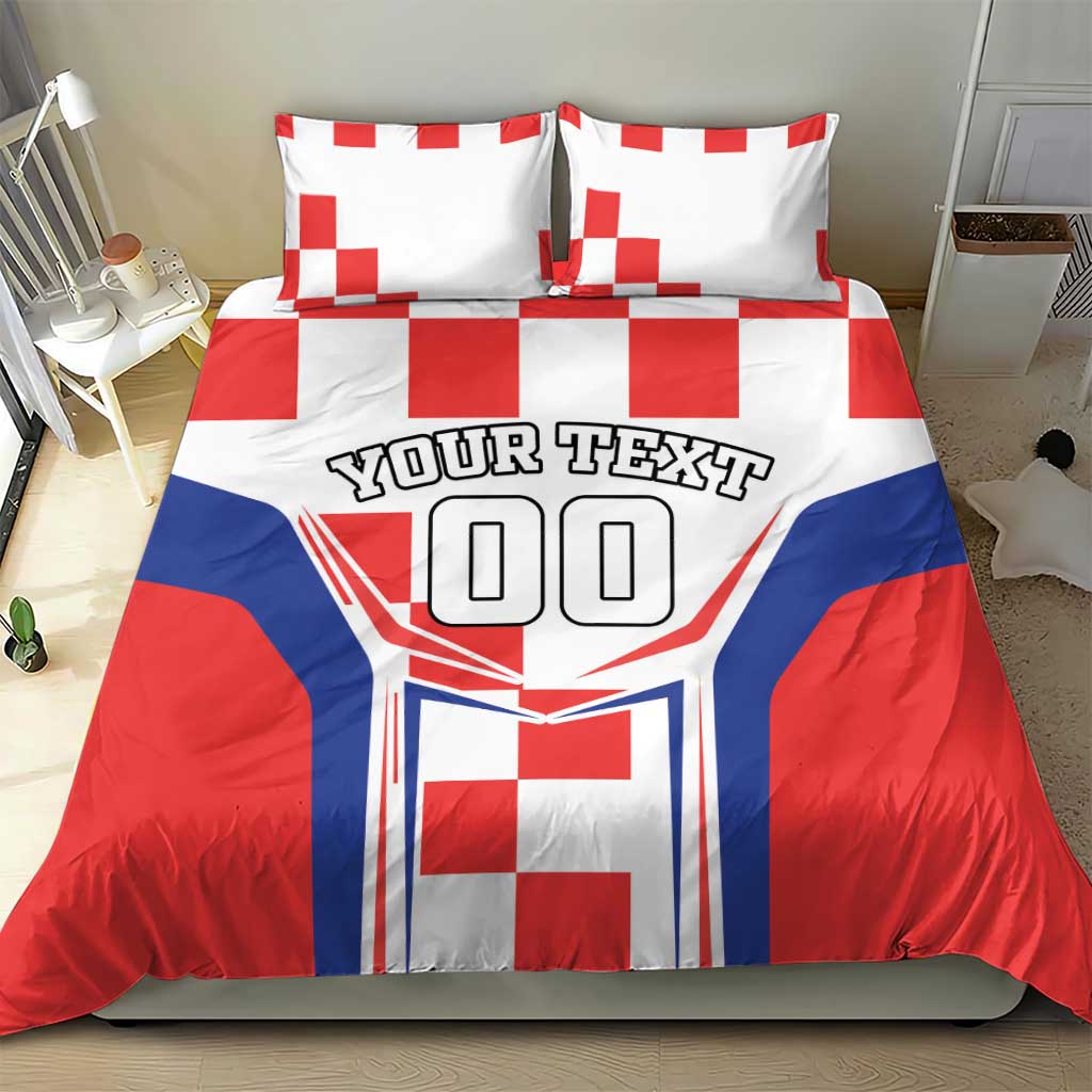 Red, white and blue bedding set with two pillows, checkerboard accents and 'YOUR TEXT' crest.