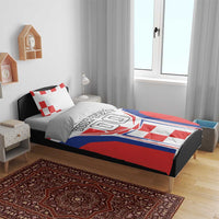 Red, white and blue bedding set with pillow; crest graphic and 'YOUR TEXT' on duvet.