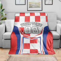 Red, white, and blue checkerboard blanket draped over couch; 'YOUR TEXT' and '00' print